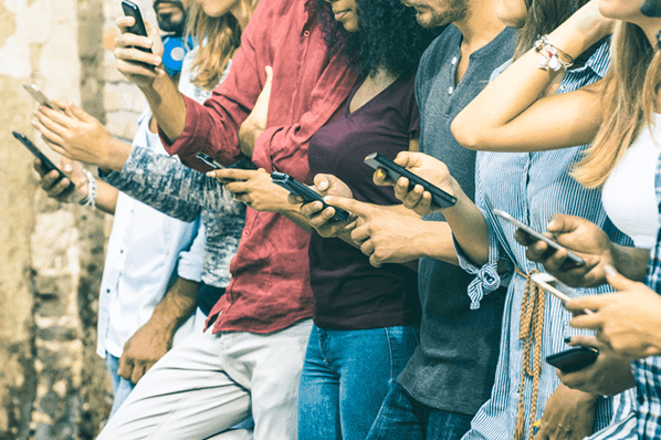 people in a line all holding their phones